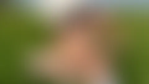 Im transparenten Dessous in der Frühlingswiese streichle ich mit einem Löwenzahn meine nackte Brust